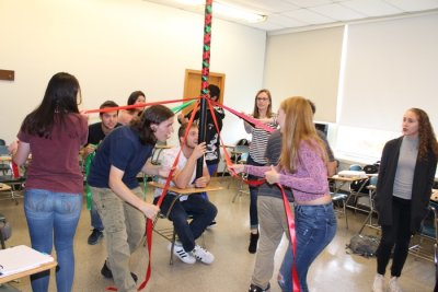 Students dancing around a maypole in their mathematics class.