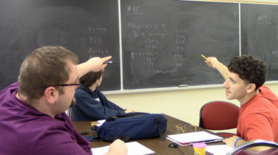 IBL classroom: Students discussing their board work.